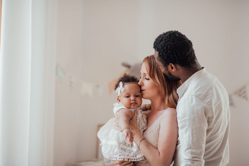 Parents sitting together with their baby during a postnatal check-in