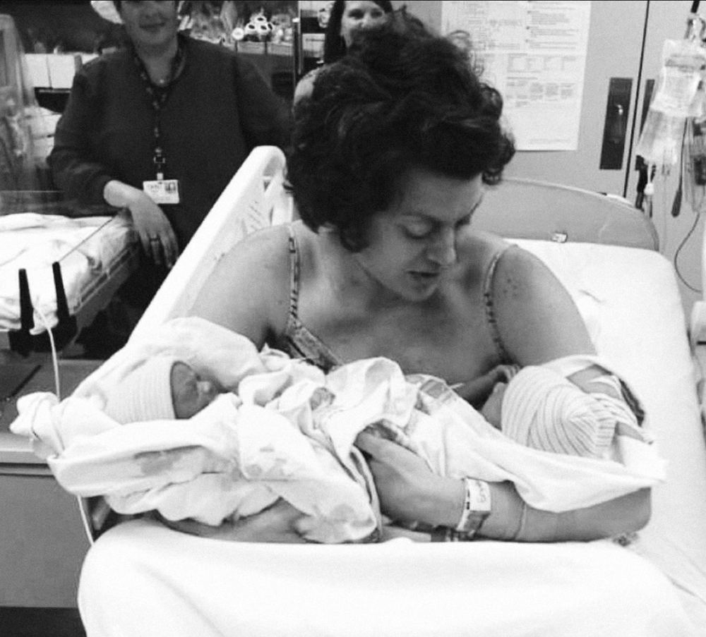 Cameron in hospital holding her newborn twins